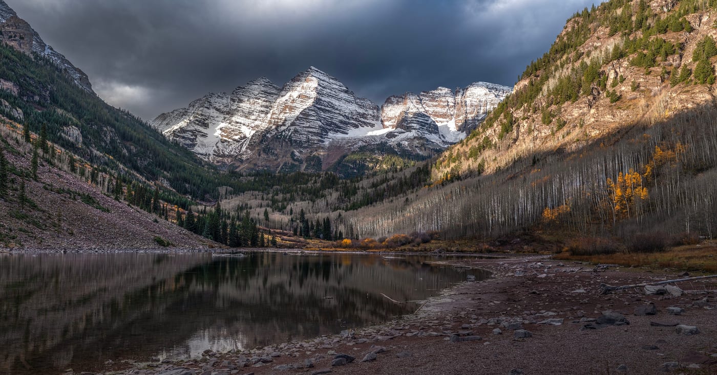 The Maroon Bells in the Colorado Rocky Mountains near Aspen. Colorado opened licensing under the Natural Medicine Health Act (SB23-290) on the last day of 2024. The state framework differs from Oregon in granting adults a personal-use right alongside the supervised-therapy framework.