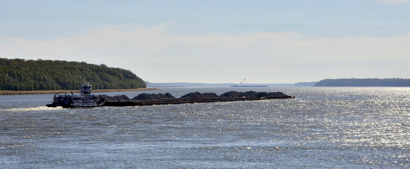 A grain barge on the Mississippi River. The river is the Cargill logistical spine for moving Midwestern grain from the interior to the Gulf of Mexico export terminals.