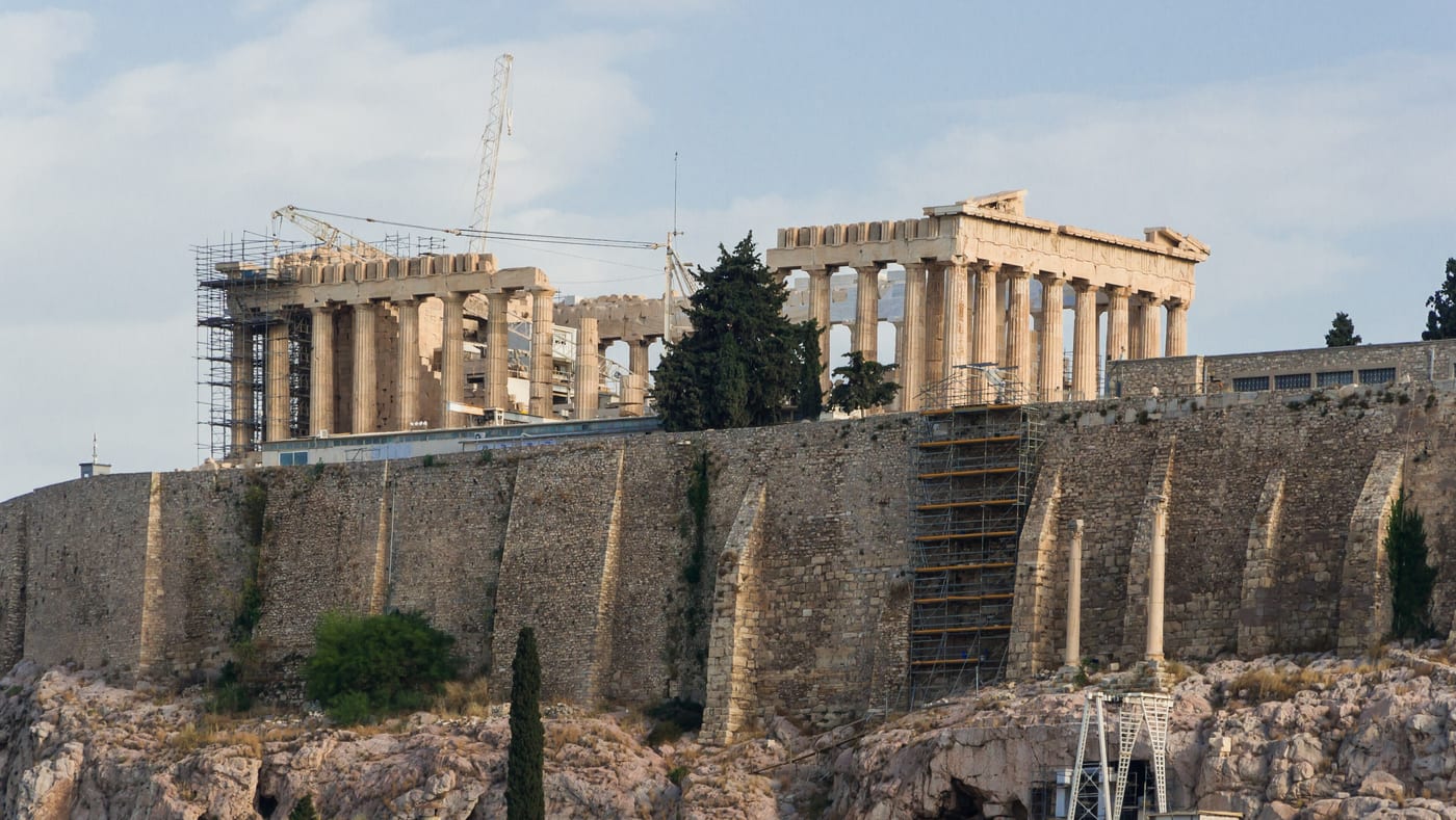 The Parthenon on the Acropolis of Athens during ongoing restoration. The institutional anchor of the city that the trophy-property market is now organising around.