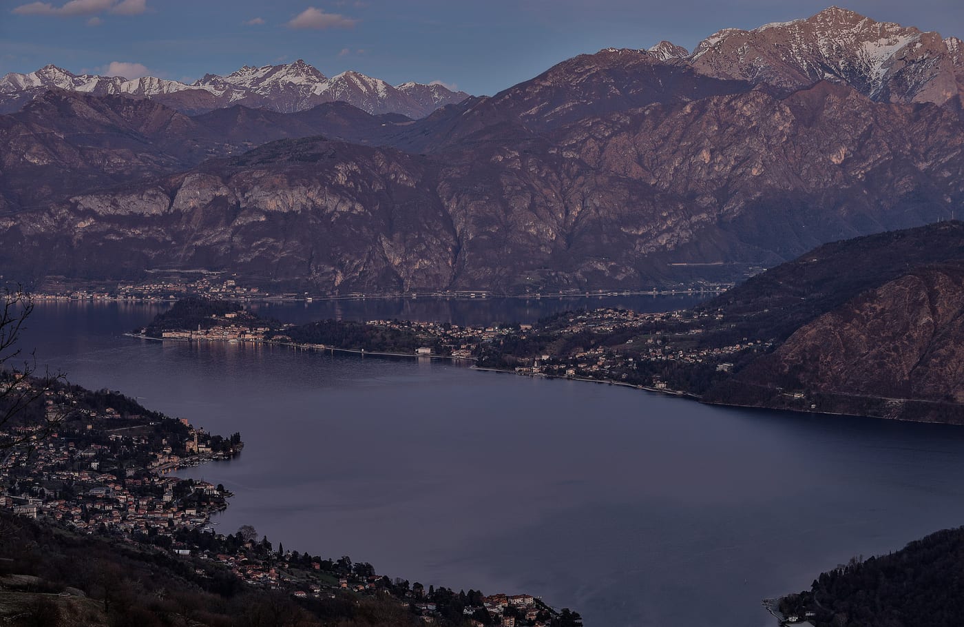 Bellagio sits on a promontory between the two southern arms of Lake Como. Northern Italy beyond Milan absorbs the senior tier of the country-villa post-non-dom relocation cohort.