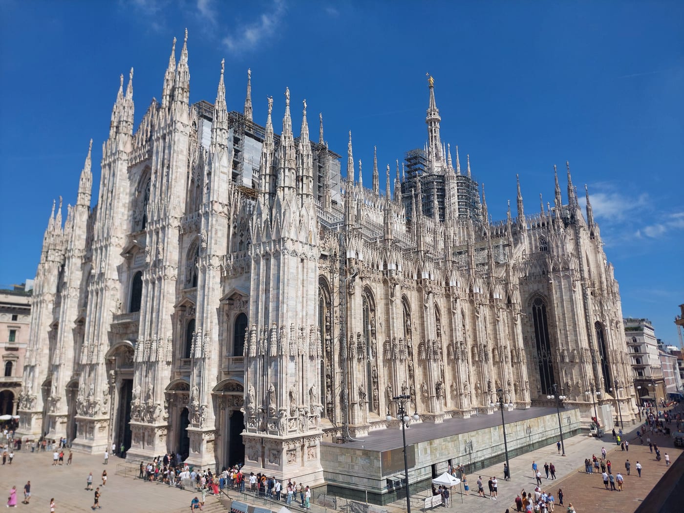 The Gothic facade of the Milan Cathedral in late-summer light. Milan as the residential anchor of Italy's non-dom flat-tax regime and the financial capital absorbing the largest single share of the post-non-dom European inflow.