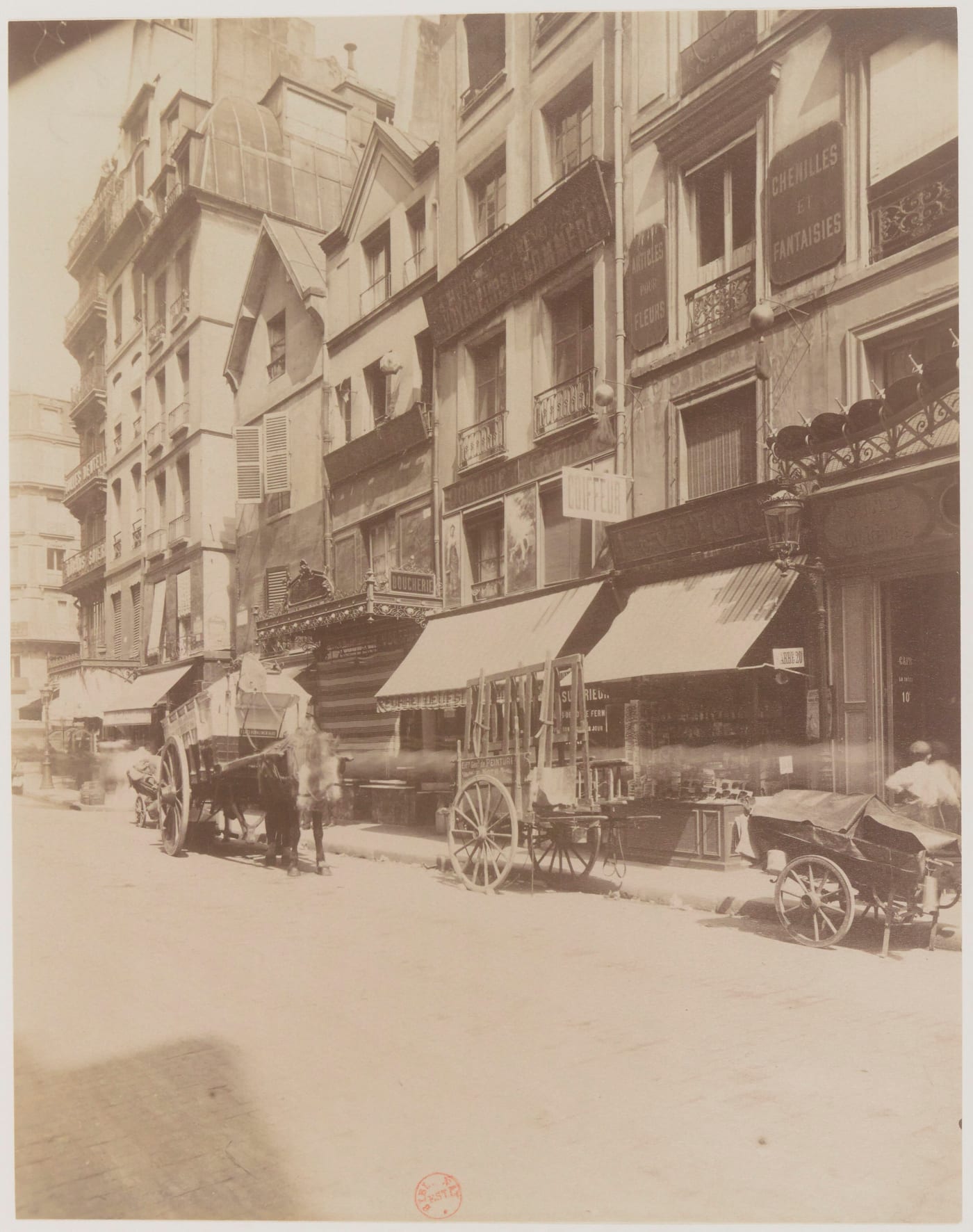 Eugène Atget's photograph of 174 rue Saint-Denis in Paris, an early 1900s building with a distinctive pignon facade. Atget's systematic Paris documentation is one of the canonical vintage-era photography categories.