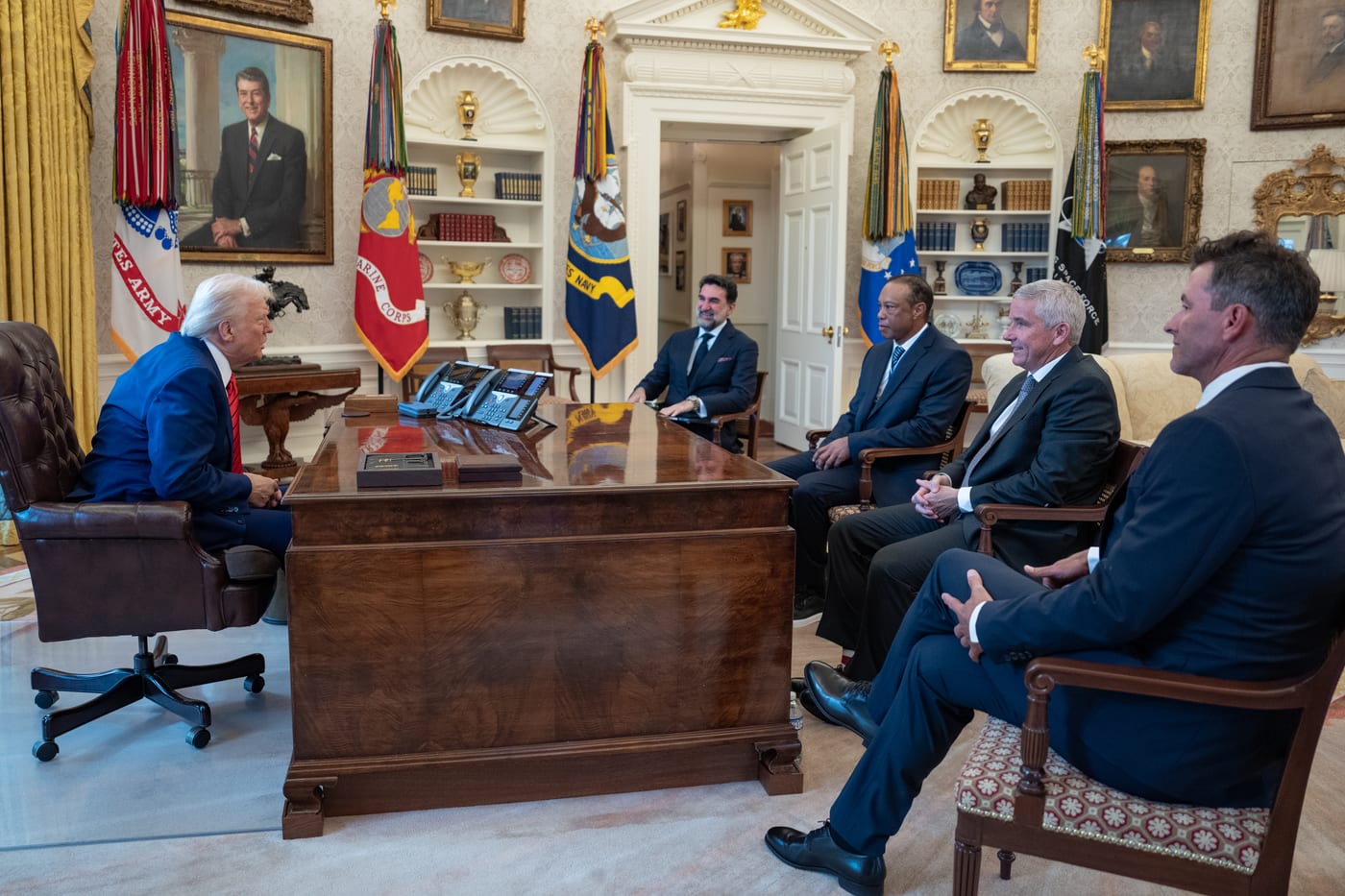 President Donald Trump meets in the Oval Office on 20 February 2025 with Tiger Woods, Yasir Al-Rumayyan, and Adam Scott. The meeting at which the LIV Golf and PGA Tour merger pathway was discussed and which preceded PIF's April 2026 decision to end LIV Golf funding after the 2026 season.