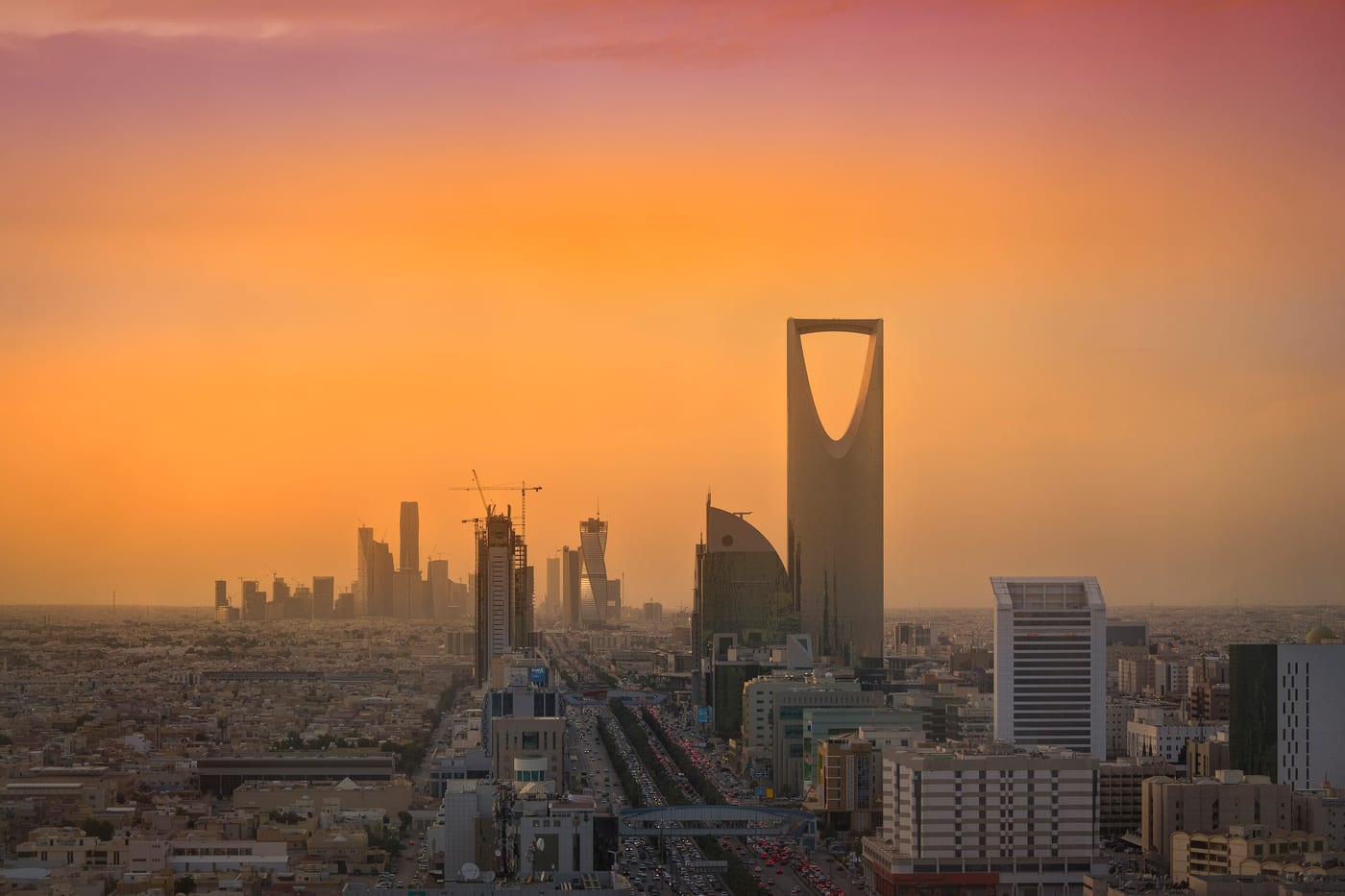 The Riyadh skyline in late-afternoon light, showing the King Abdullah Financial District (KAFD) towers and the Kingdom Tower. The operational seat of the Saudi Public Investment Fund.